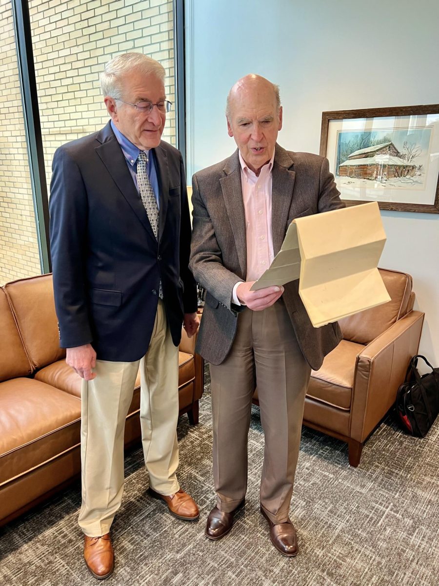 Dr. Bruce McAllister, BJU president (left), is presented with the original Bob Jones College charter by Dr. John Matsko, the university's historical consultant, on April 6, 2026. 