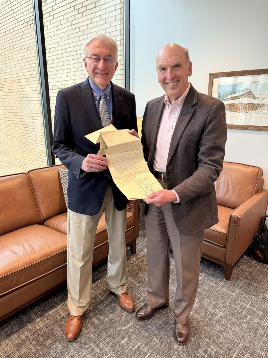Dr. Bruce McAllister, BJU president (left), is presented with the original Bob Jones College charter by Dr. John Matsko, the university's historical consultant, on April 6, 2026. 